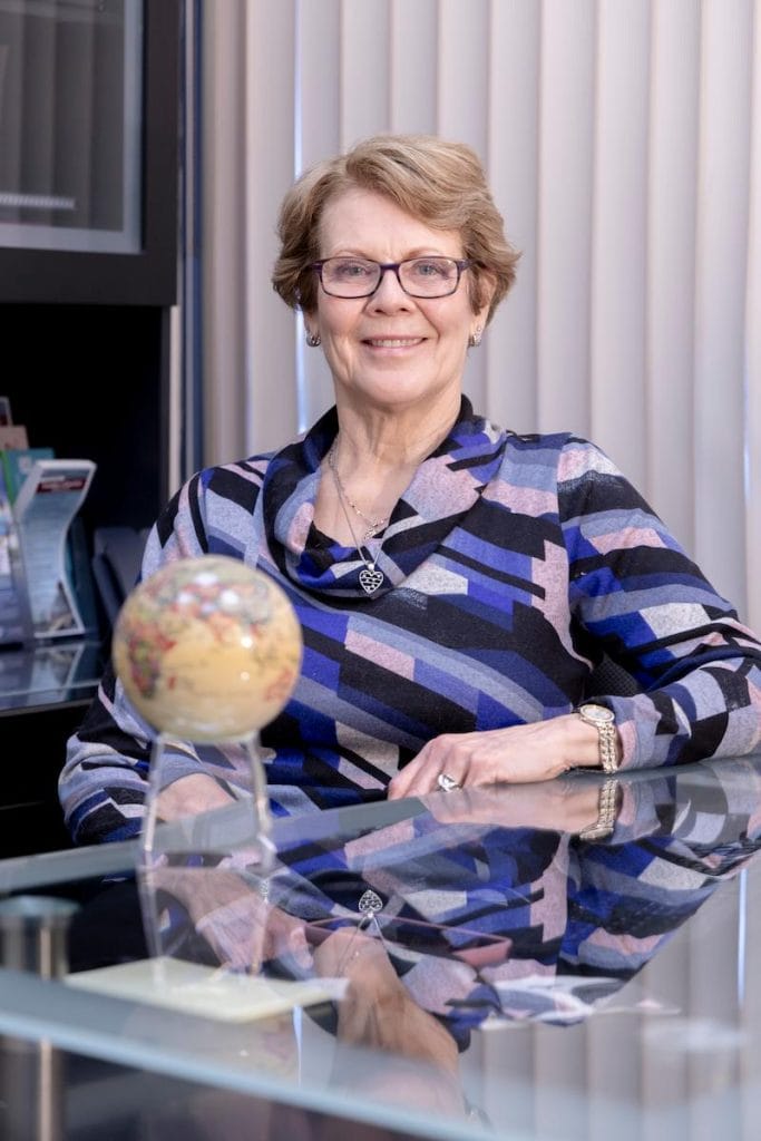 Portrait of Orleans travel health doctor: Dr. Bruce sitting at a desk